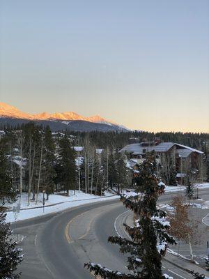 Room with a view of the city and mountain.