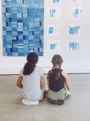 Students studying the art in the gallery