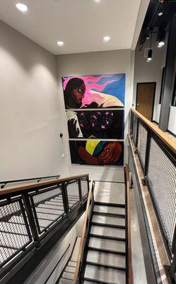 Interior staircase with colorful local artwork