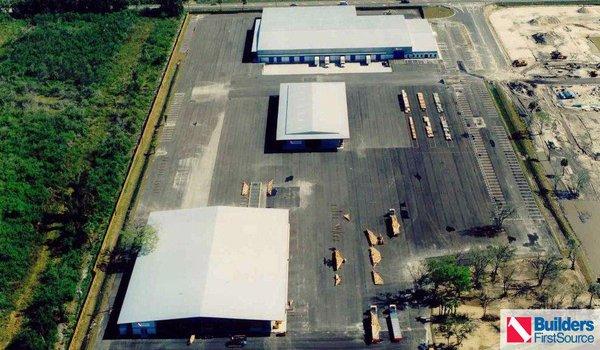 Building materials supplier Builders FirstSource's forklift is moving wood roof trusses.