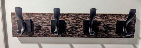 This is a piece of black palm made into a towel rack. It has a simple clear finish, no stain.