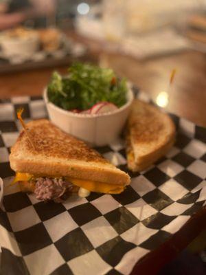 Short Rib Grilled Cheese, with a side salad.