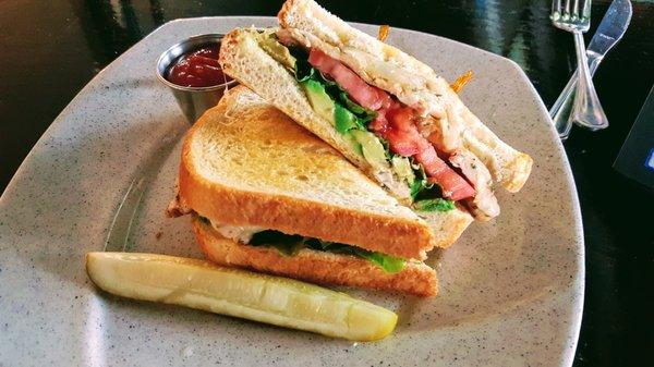 Chicken club on toasted sourdough with Swiss cheese, bacon, lettuce, tomato, onion & mayo.