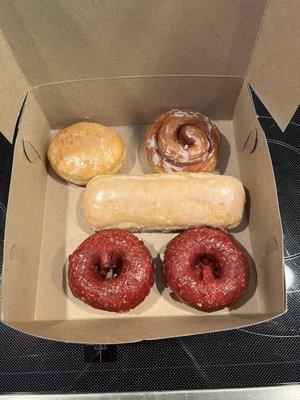 The donuts we got. Strawberry filled, cinnamon roll, maple bar, x2 red velvet