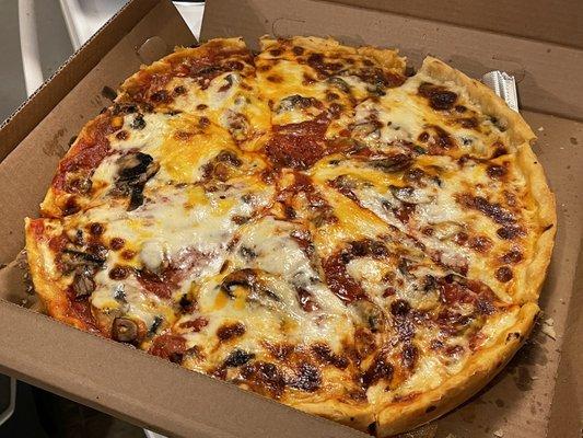 Large pepperoni and mushroom cheese topper pizza.