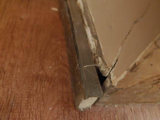 Damaged wall, leaving a hole in my wall, and poorly glued stone.