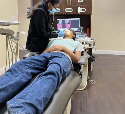 Hygienist cleaning teeth. She was very nice.