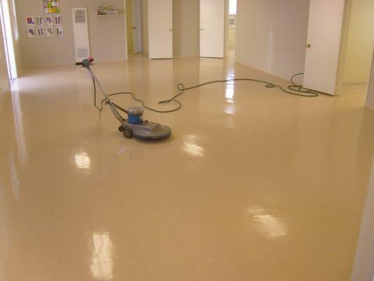 Floors being stripped waxed then buffed with high speed burnisher.