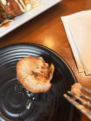 TAKOYAKI Fried octopus dumplings drizzled with Kewpie Mayo, katsu sauce and sprinkled with scallions.