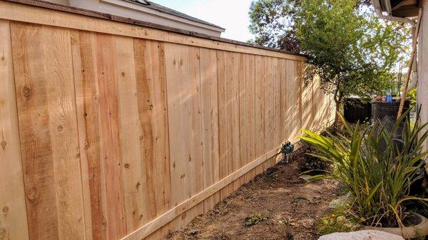 Smooth side of 6 ft picture frame, postmaster posts cedar fence.