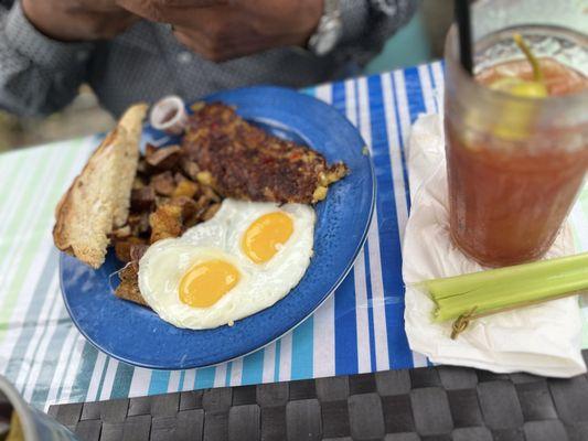 House made Corned beef hash with sweet bell peppers, sourdough toast and eggs over easy.