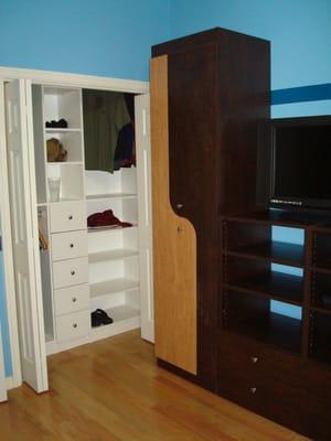 Custom Built Wardrobe/Entertainment unit next to reach in closet in white.