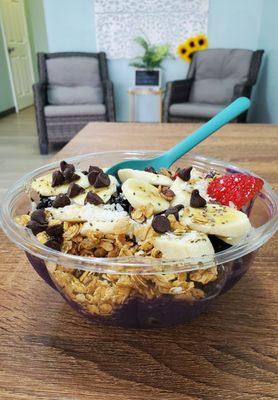 Acai smoothie bowl with bananas, strawberries, blackberries, and blueberries.