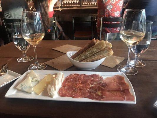 Happy hour white wine and cheese/meat plate! It's served with freshly toasted bread and olive oil