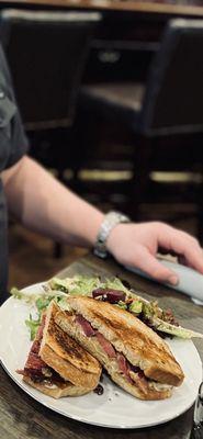 Brisket sandwich with side salad.