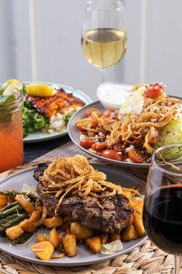 Mama's New York Steak with fried onion strings, served with soup or salad, mashed potatoes
 and seasonal veggies