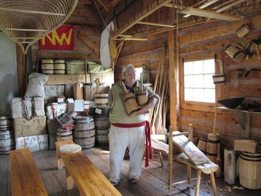 Living history interpretation. Here the cooper shows off his work, including a butter churn that makes fabulous butter.