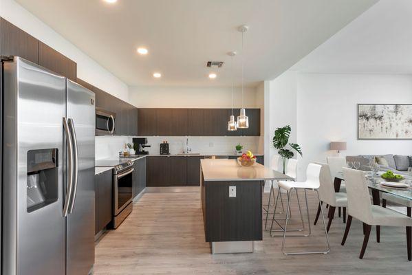 Gourmet kitchen with quartz countertops, stainless steel Samsung Smart Appliances, and spacious island at Lantower River Landing.