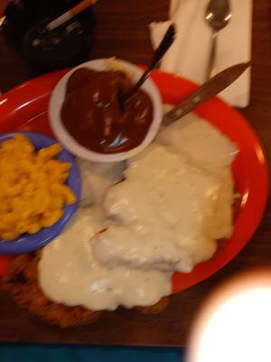 Double portion chicken fried steak with macaroni and cheese and mashed potatoes and brown gravy