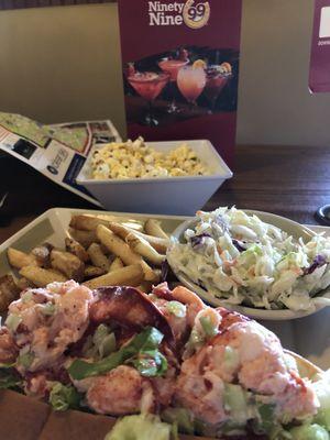 Lobster roll with sides of slaw and fries