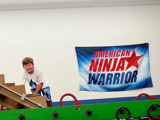 My 9 year old son atop one of the obstacles at Kings Camps & Fitness.