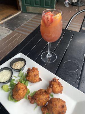 Summer sangria with rotten, moldy strawberry, corn and crab fritters. Very good. I also had the blue cheeseburger.