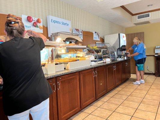 Breakfast staff and customer.