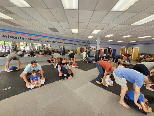 Father's working with their student children during a Father's Day class.