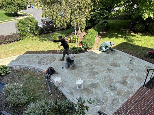 Painting in the grout and finishing the hand-applied coloration.