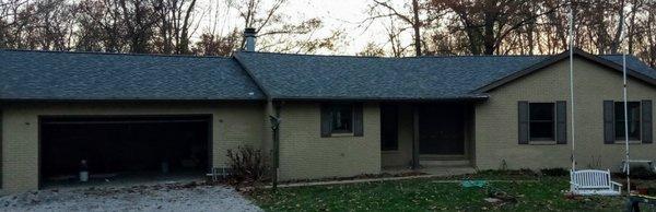 Previously red brick air bnb in Boonville doubled as a hunting/ fishing lodge. Draped  with beautiful furniture nestled on a deck side pond.