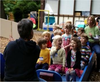 Story time outside with Teacher Marty and Teacher Lisa