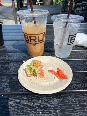 Bagel sandwich and cold brew coffee with oat milk