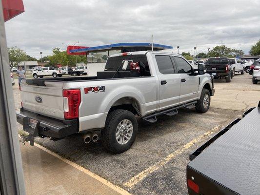 Custom side steps with a brush guard by Ranch Hand and diesel tank.  She drives like a champion!