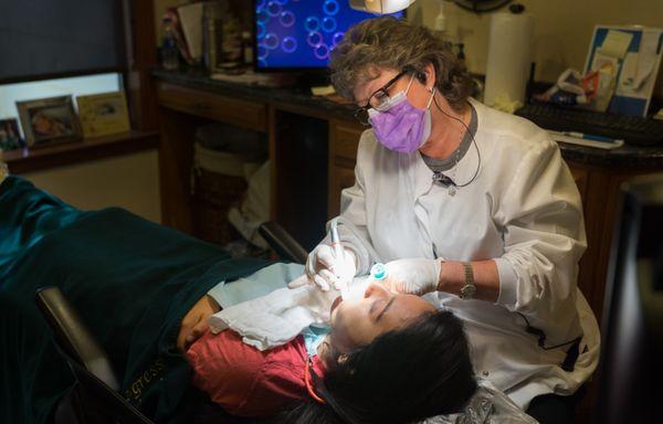 Hygienist Debbie King working with a patient.