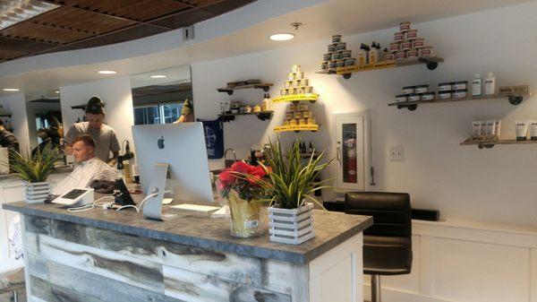 The front reception desk. Lined with tons of hair products and repurposed wood.