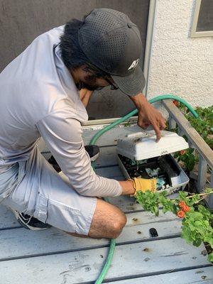 Refilling the food in the rodent box.