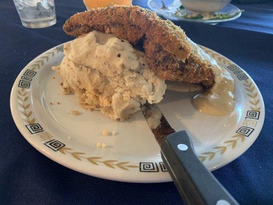 Chicken fried steak over homemade mashed potatoes; view one.