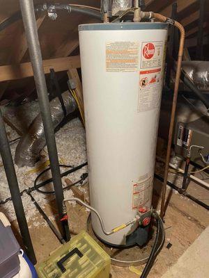 Tanked water heater installed in an attic of an Austin residence.