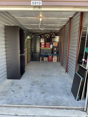 Moving a residence and unloading/arranging into their storage unit.