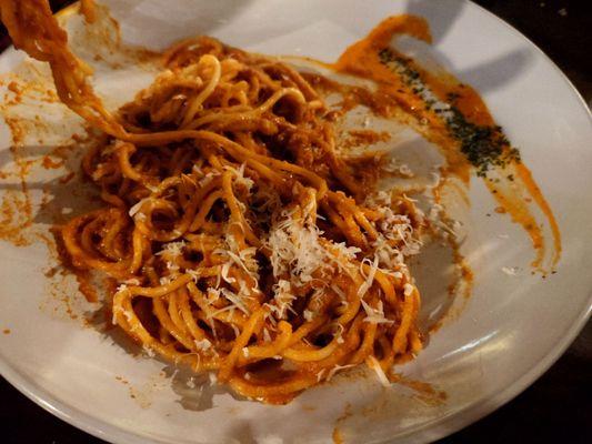 Spaghetti Bolognese - topped with grated Parmesan cheese