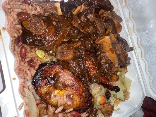 Braised oxtail   Plantain, rice/peas and cabbage/veggies