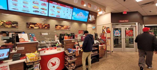 View of deli counter. Self-Serve machines for placing orders