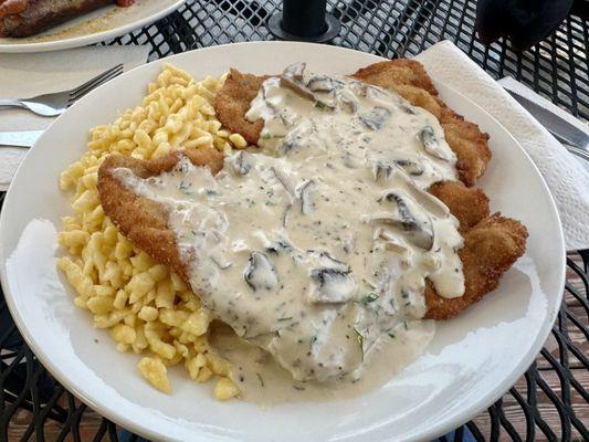 Schnitzel with mushroom gravy and spaetzel. I ordered it with the gravy. I believe it's usually served without.