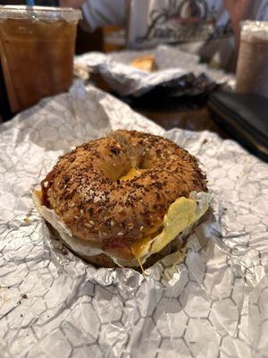 Bacon, egg, cheddar cheese, & hash brown on toasted everything bagel.