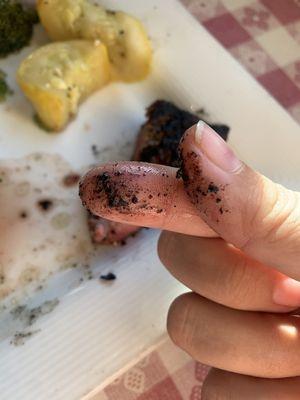 The charcoal I got on my hands from the meat when I touched it.