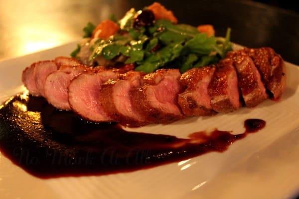 Duck Breast with cherry molasses and arugula salad with cherries and corn bread croutons.