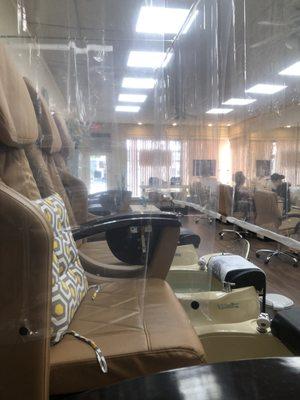 All pedicure chairs surrounded by coverings