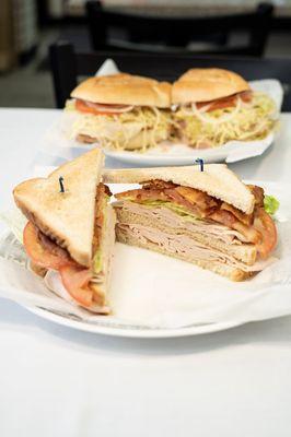 Turkey and Bacon Club. Triple-decker sandwiches served with lettuce, tomato and mayo.