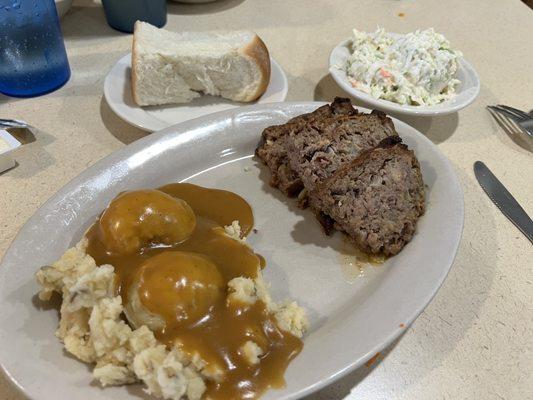 Meatloaf with mashed potatoes, coleslaw and roll.