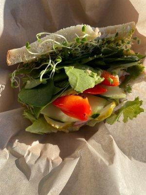 Veggie sandwich on sourdough with hummus instead of cream cheese and added spinach and red pepper. Fresh, fast  and delicious.